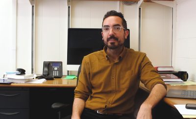 Ian Shoemaker in front of his computer in an office 