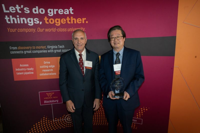 Executive Vice President and Provost Cyril Clarke (left) presented National Academy member and University Distinguished Professor X.J Meng with the Lifetime Achievement Innovator award at the Celebrating Innovation event on April 24. Photo by Clark DeHart for Virginia Tech.