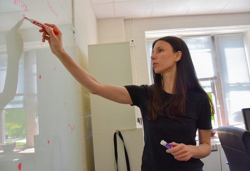 Sophia Economou writes on a white board